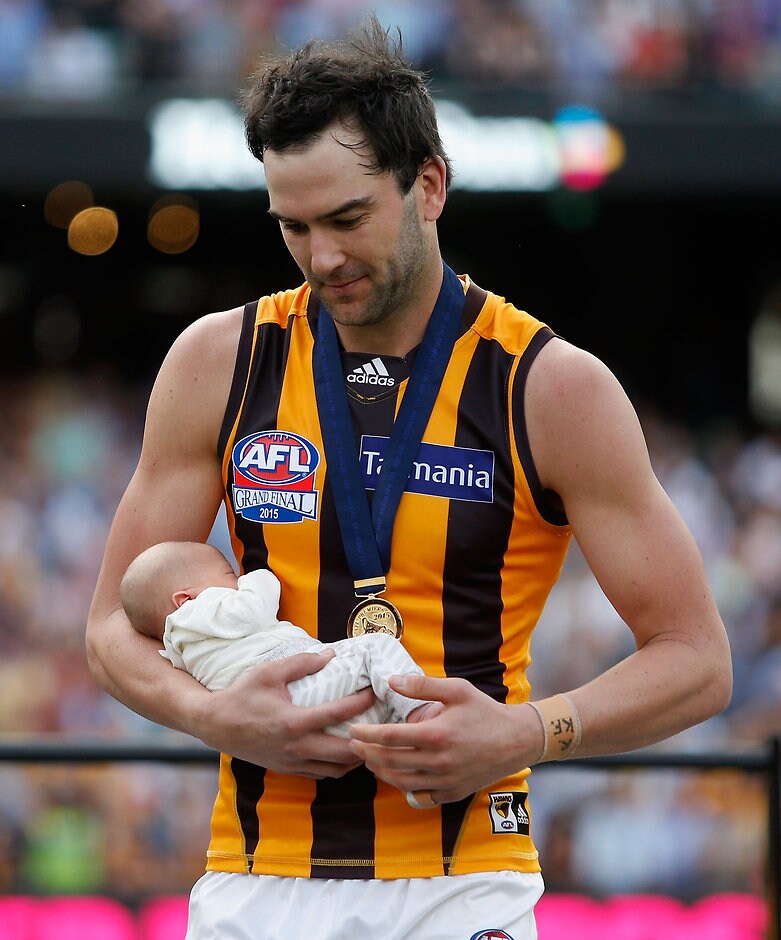 2015 Toyota AFL Grand Final - Hawthorn v West Coast MELBOURNE, AUSTRALIA - OCTOBER 3: Jordan Lewis of the Hawks receives his premiership medal with his baby boy after winning the 2015 Toyota AFL Grand Final match between the Hawthorn Hawks and the West Coast Eagles at the Melbourne Cricket Ground, Melbourne, Australia on October 3, 2015. (Photo by Sean Garnsworthy/AFL Media)